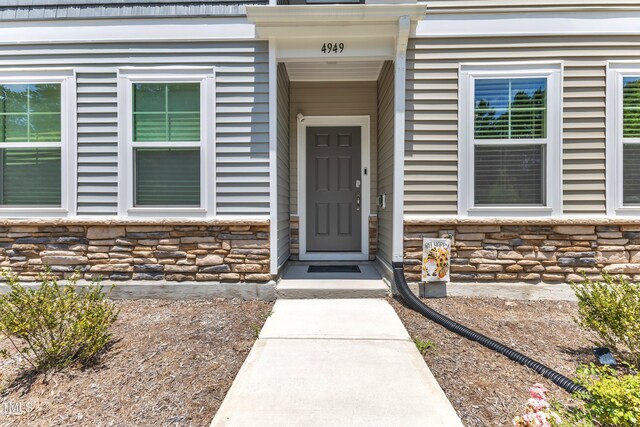 4949 Microcline Trl, Raleigh, NC 27610 - doorway to property featuring stone siding