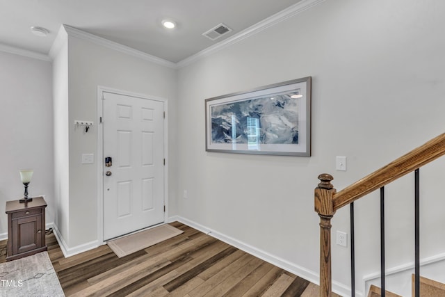 4949 Microcline Trl, Raleigh, NC 27610 - entrance foyer featuring wood finished floors, crown molding, and stairway