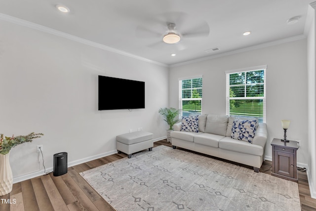 4949 Microcline Trl, Raleigh, NC 27610 - living area featuring ceiling fan, wood finished floors, crown molding, and recessed lighting
