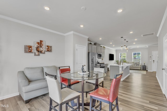4949 Microcline Trl, Raleigh, NC 27610 - dining area with ornamental molding, light wood-style flooring, and recessed lighting