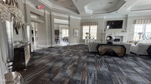 4949 Microcline Trl, Raleigh, NC 27610 - carpeted living room with a fireplace, healthy amount of natural light, a raised ceiling, and ornamental molding