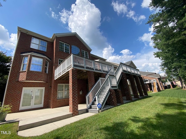 10108 Sporting Club Dr, Raleigh, NC 27617 - rear view of property with brick siding, a lawn, stairs, a wooden deck, and french doors