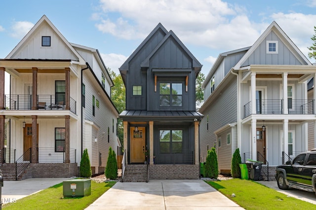 409 S Tunstall Ave, Apex, NC 27502 - modern inspired farmhouse featuring board and batten siding, covered porch, a balcony, and a front lawn