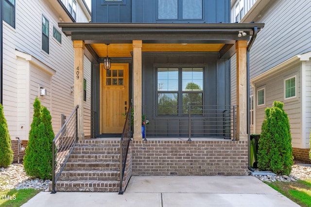 409 S Tunstall Ave, Apex, NC 27502 - doorway to property featuring board and batten siding and a porch