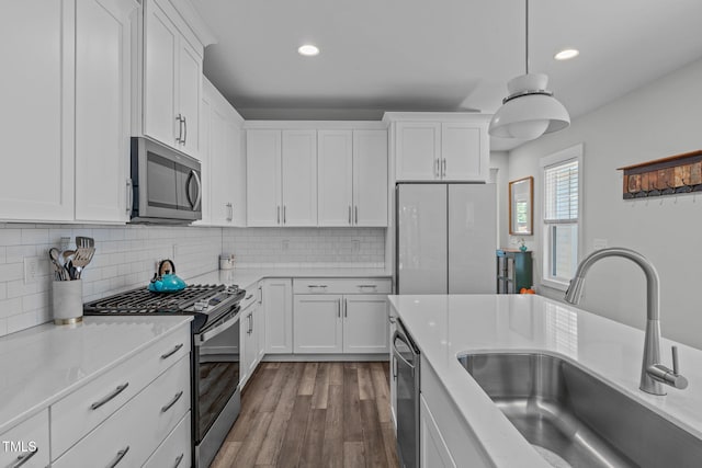 409 S Tunstall Ave, Apex, NC 27502 - kitchen with stainless steel appliances, recessed lighting, white cabinets, dark wood-style flooring, and decorative backsplash