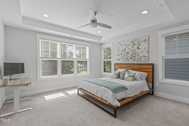 409 S Tunstall Ave, Apex, NC 27502 - carpeted bedroom featuring a tray ceiling, recessed lighting, and ceiling fan