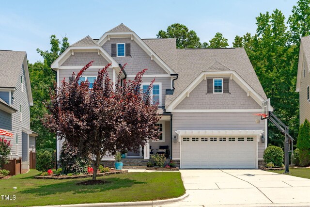 2716 Lake Waccamaw Trl, Apex, NC 27502 - craftsman-style house with driveway, a front yard, roof with shingles, and stone siding