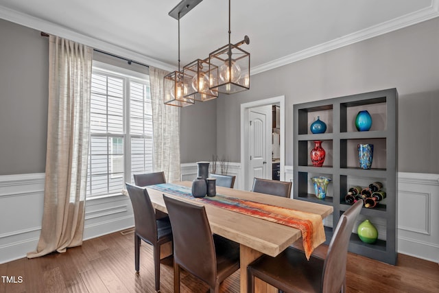 2716 Lake Waccamaw Trl, Apex, NC 27502 - dining space featuring a chandelier, crown molding, a wainscoted wall, and dark wood-style floors