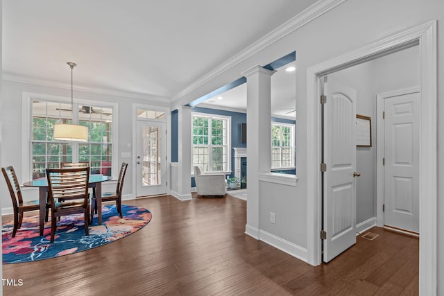 2716 Lake Waccamaw Trl, Apex, NC 27502 - dining area with a fireplace, wood finished floors, and ornamental molding