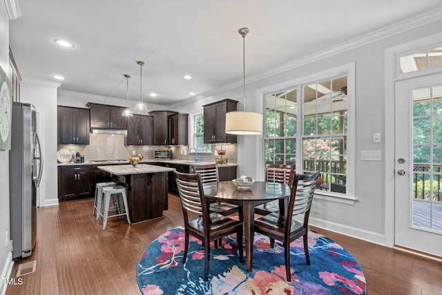 2716 Lake Waccamaw Trl, Apex, NC 27502 - dining area with plenty of natural light, dark wood-style flooring, crown molding, and recessed lighting