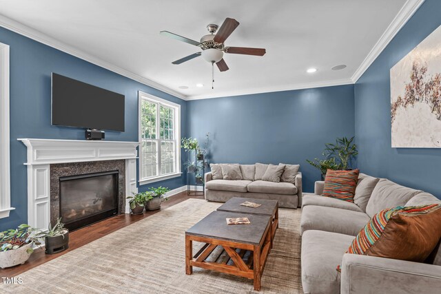 2716 Lake Waccamaw Trl, Apex, NC 27502 - living room with ceiling fan, ornamental molding, wood finished floors, recessed lighting, and a fireplace