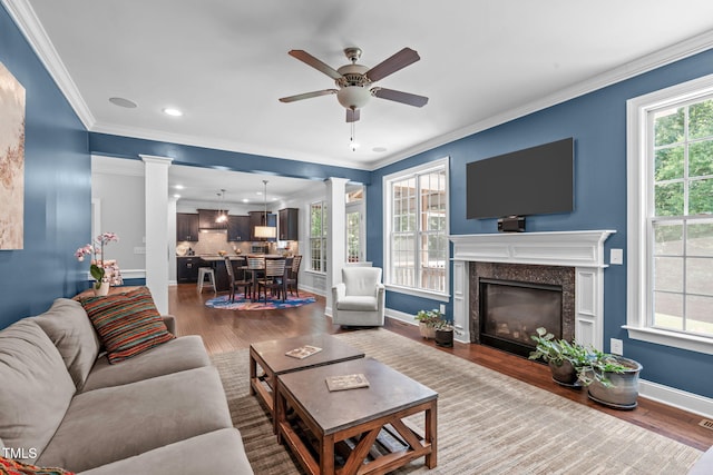 2716 Lake Waccamaw Trl, Apex, NC 27502 - living area with decorative columns, ceiling fan, dark wood-style flooring, recessed lighting, and a fireplace
