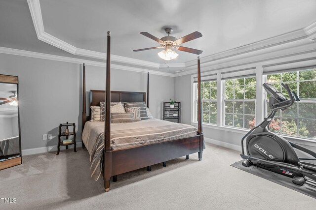 2716 Lake Waccamaw Trl, Apex, NC 27502 - carpeted bedroom featuring ornamental molding, a tray ceiling, and ceiling fan