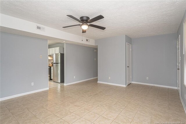 2408 Crabtree Ct, Fayetteville, NC 28304 - empty room with a ceiling fan, a textured ceiling, and light tile patterned floors