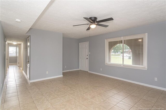 2408 Crabtree Ct, Fayetteville, NC 28304 - empty room featuring a ceiling fan, a textured ceiling, light tile patterned floors, and a smoke detector