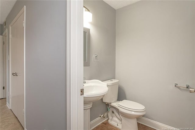 2408 Crabtree Ct, Fayetteville, NC 28304 - half bathroom featuring a textured ceiling and tile patterned flooring