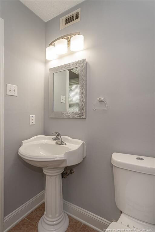 2408 Crabtree Ct, Fayetteville, NC 28304 - bathroom with baseboards and tile patterned floors