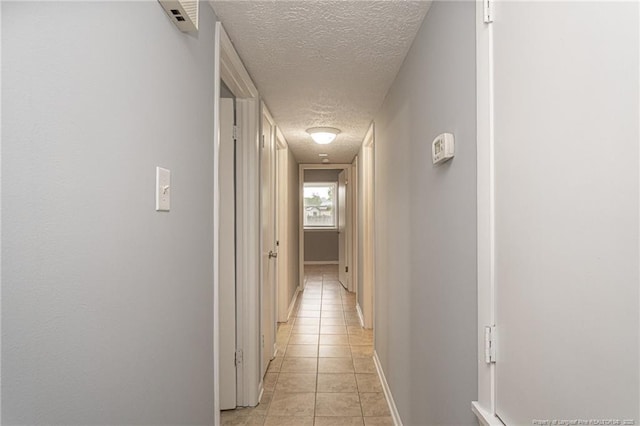 2408 Crabtree Ct, Fayetteville, NC 28304 - hallway featuring a textured ceiling and light tile patterned floors