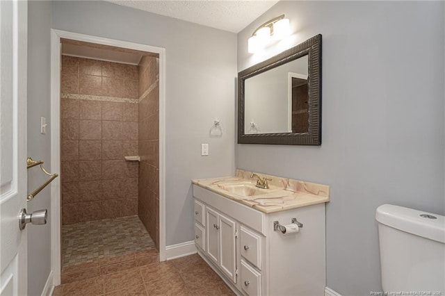 2408 Crabtree Ct, Fayetteville, NC 28304 - bathroom with vanity, a tile shower, and tile patterned flooring
