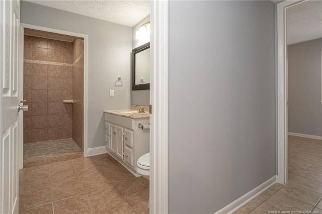 2408 Crabtree Ct, Fayetteville, NC 28304 - bathroom featuring vanity, tile patterned floors, a walk in shower, and a textured ceiling