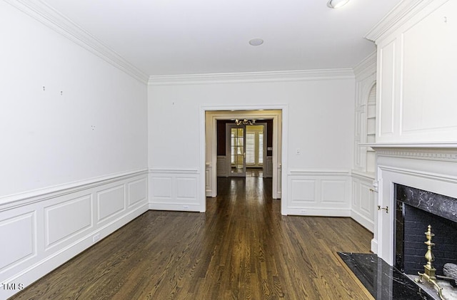3112 Lake Pointe Trl, Rocky Mount, NC 27804 - unfurnished living room featuring crown molding, dark wood-style flooring, a high end fireplace, a wainscoted wall, and a decorative wall