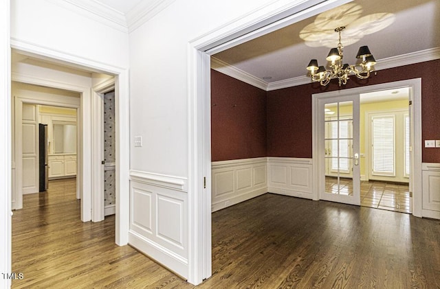 3112 Lake Pointe Trl, Rocky Mount, NC 27804 - unfurnished dining area with a chandelier, crown molding, wood finished floors, and wainscoting