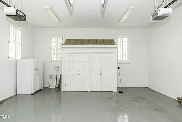 3112 Lake Pointe Trl, Rocky Mount, NC 27804 - garage with white fridge with ice dispenser and a garage door opener