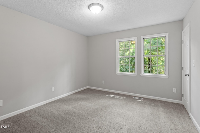 4242 Kaplan Dr, Raleigh, NC 27606 - carpeted spare room with a textured ceiling and baseboards