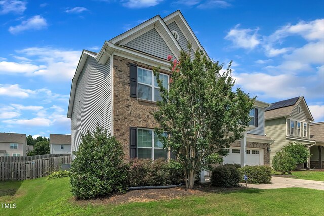 316 Vintage Holly Dr, Durham, NC 27703 - view of front of house featuring a garage, driveway, and brick siding