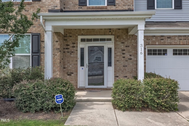 316 Vintage Holly Dr, Durham, NC 27703 - property entrance featuring brick siding and a garage