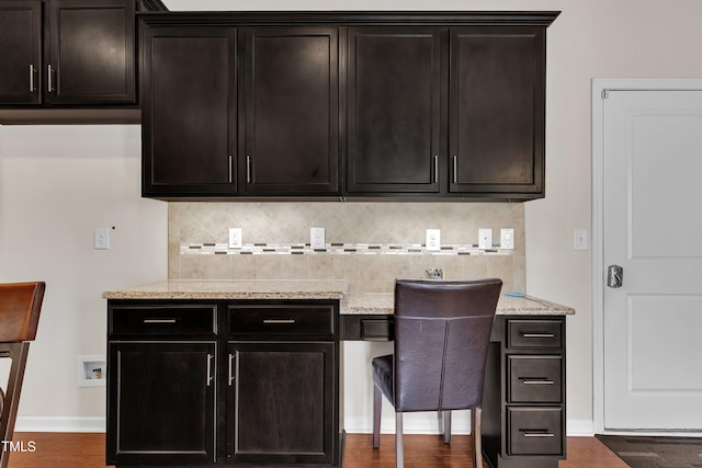 316 Vintage Holly Dr, Durham, NC 27703 - bar area featuring decorative backsplash, wood finished floors, and built in study area