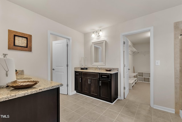 316 Vintage Holly Dr, Durham, NC 27703 - full bathroom with vanity, a walk in closet, and tile patterned flooring
