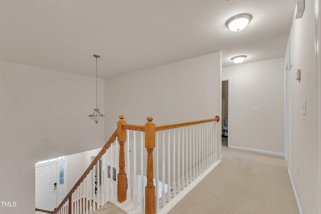 316 Vintage Holly Dr, Durham, NC 27703 - hallway with an upstairs landing and light carpet