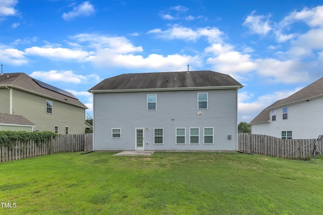 316 Vintage Holly Dr, Durham, NC 27703 - back of property with a fenced backyard and a patio