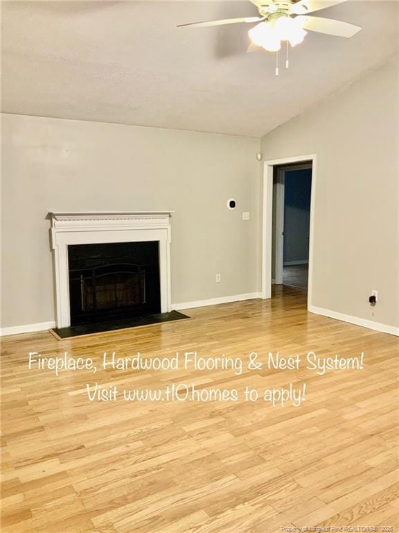 101 Horace Ct, Raeford, NC 28376 - unfurnished living room featuring wood finished floors, a ceiling fan, lofted ceiling, and a fireplace