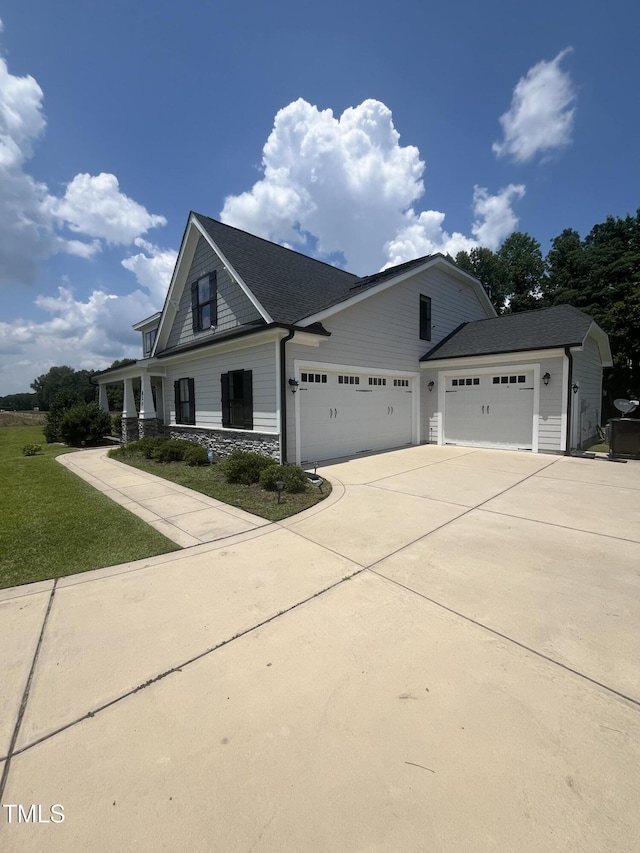 820 Christian Light Rd, Fuquay Varina, NC 27526 - view of front facade featuring concrete driveway, a garage, stone siding, and a front lawn