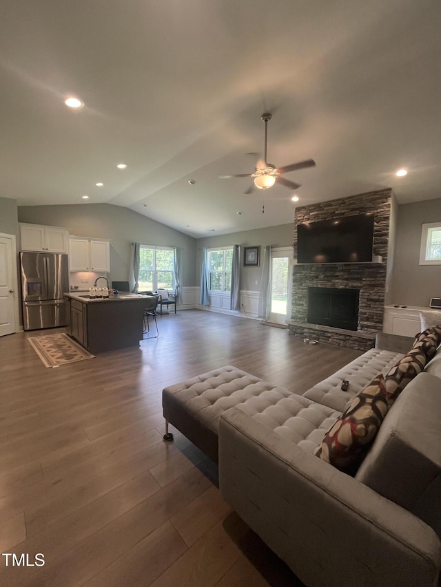 820 Christian Light Rd, Fuquay Varina, NC 27526 - living area with lofted ceiling, wood finished floors, ceiling fan, a fireplace, and recessed lighting