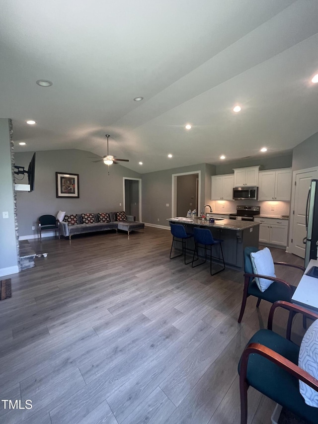 820 Christian Light Rd, Fuquay Varina, NC 27526 - living room with vaulted ceiling, dark wood-style floors, ceiling fan, and recessed lighting