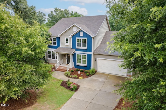 218 Inwood Forest Dr, Raleigh, NC 27603 - traditional-style house with driveway, a garage, a shingled roof, and board and batten siding
