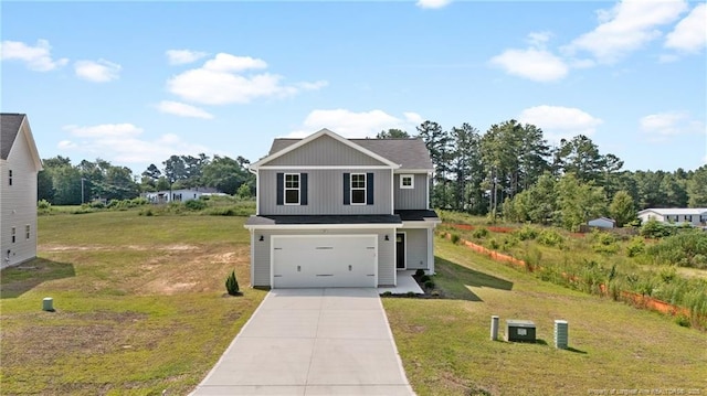 29 Red Bird Dr, Cameron, NC 28326 - traditional-style home with an attached garage, driveway, a front yard, and board and batten siding