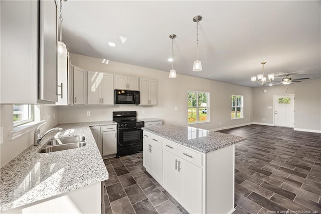 29 Red Bird Dr, Cameron, NC 28326 - kitchen with black appliances, healthy amount of natural light, a kitchen island, and a chandelier