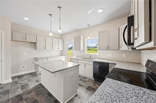 29 Red Bird Dr, Cameron, NC 28326 - kitchen with black dishwasher, stainless steel range with electric stovetop, a center island, light stone countertops, and pendant lighting