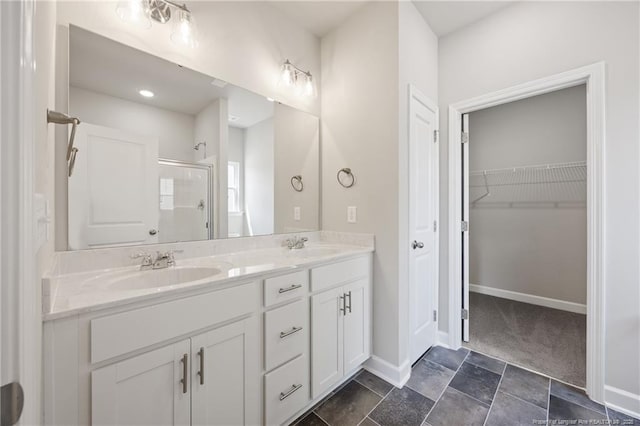 29 Red Bird Dr, Cameron, NC 28326 - full bath featuring a shower stall, double vanity, a walk in closet, and stone finish floors