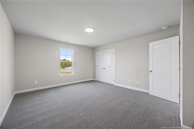 29 Red Bird Dr, Cameron, NC 28326 - unfurnished bedroom featuring dark colored carpet and a closet