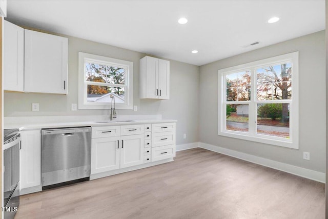 315 Byrd St, Clinton, NC 28328 - kitchen featuring stainless steel dishwasher, range, light wood-style floors, white cabinetry, and recessed lighting