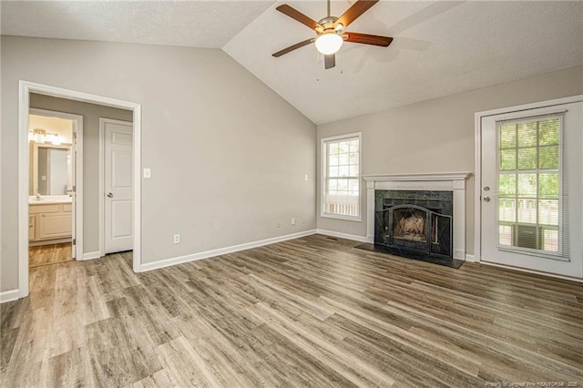 337 Buckeye Dr, Raeford, NC 28376 - unfurnished living room with vaulted ceiling, ceiling fan, wood finished floors, and a fireplace