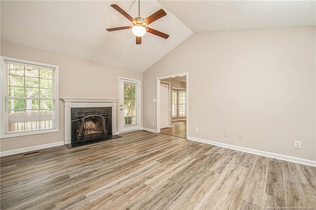 337 Buckeye Dr, Raeford, NC 28376 - unfurnished living room featuring wood finished floors, a premium fireplace, ceiling fan, and high vaulted ceiling