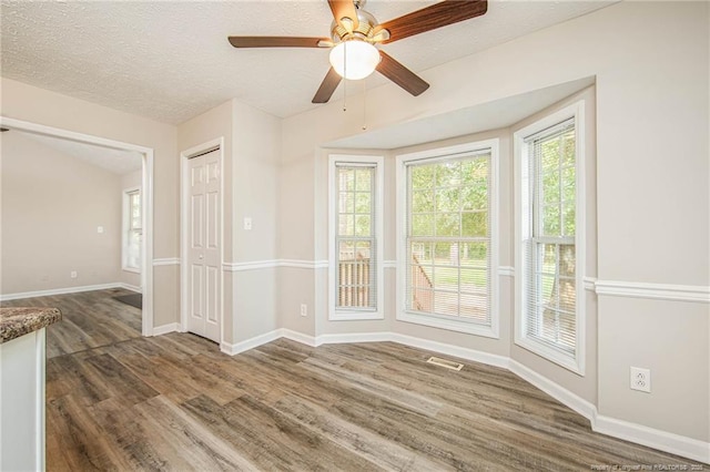 337 Buckeye Dr, Raeford, NC 28376 - unfurnished room with wood finished floors, ceiling fan, and a textured ceiling