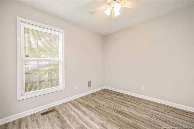 337 Buckeye Dr, Raeford, NC 28376 - empty room featuring wood finished floors, plenty of natural light, ceiling fan, and a textured ceiling