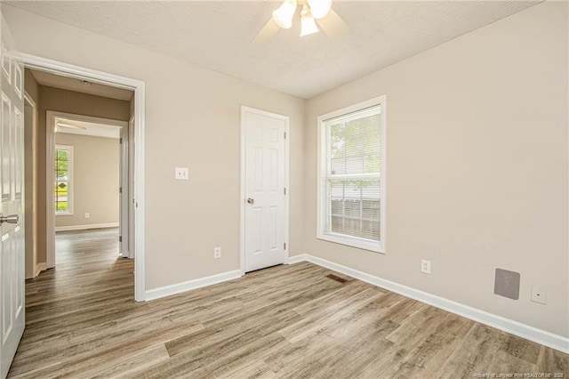337 Buckeye Dr, Raeford, NC 28376 - unfurnished room with wood finished floors, ceiling fan, and a textured ceiling